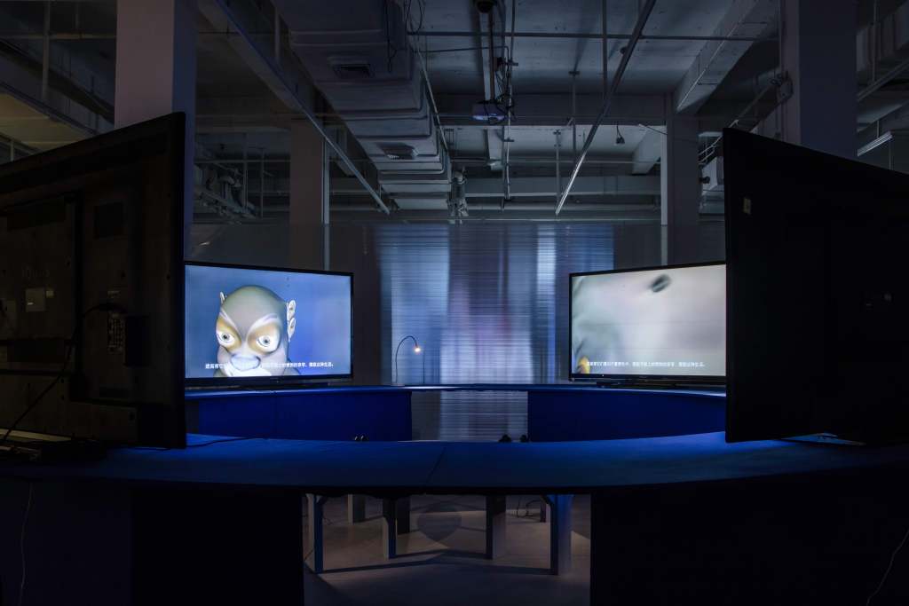 Another view of the installation for the four channel artwork, two half circles are used as platforms painted blue, while the bench is also curved but smaller and situated in the middle.
