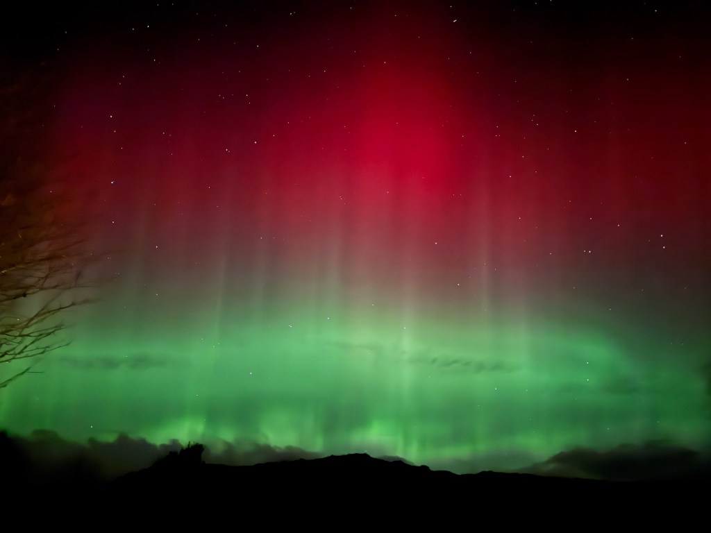 a vibrant display of red and green aurora light